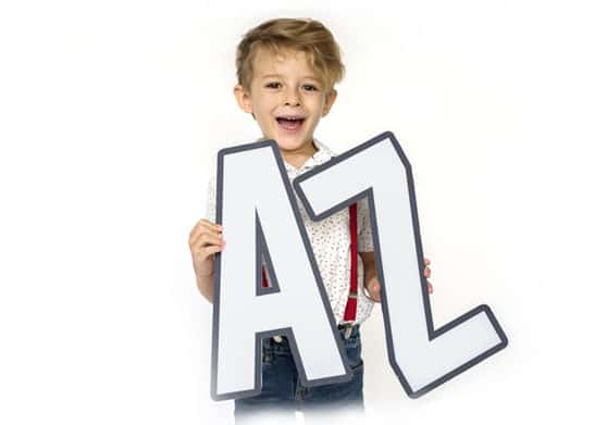 Boy holding letters A & Z, encouraging English language learning. 